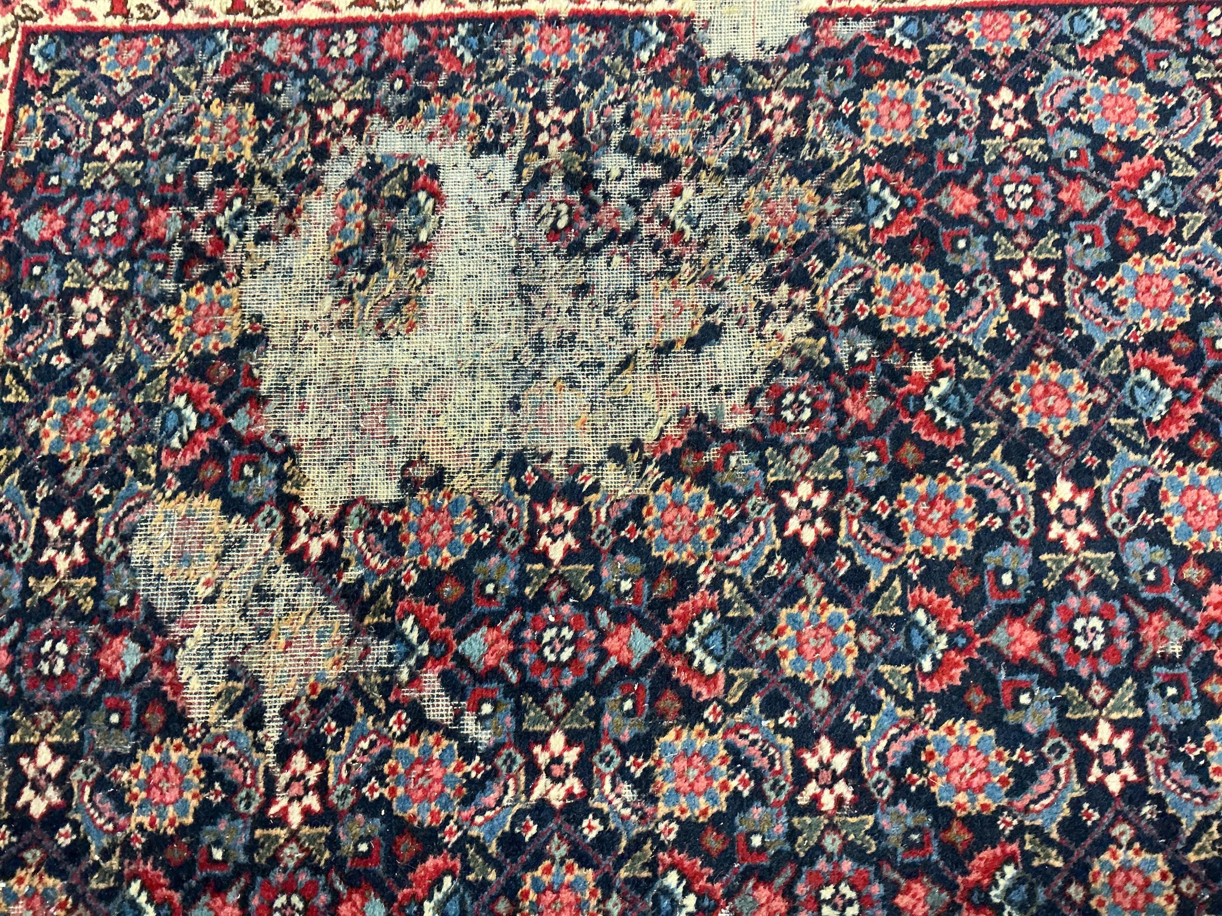An early 20th century Tabriz blue ground floral carpet, moth damage, 440 x 340cm